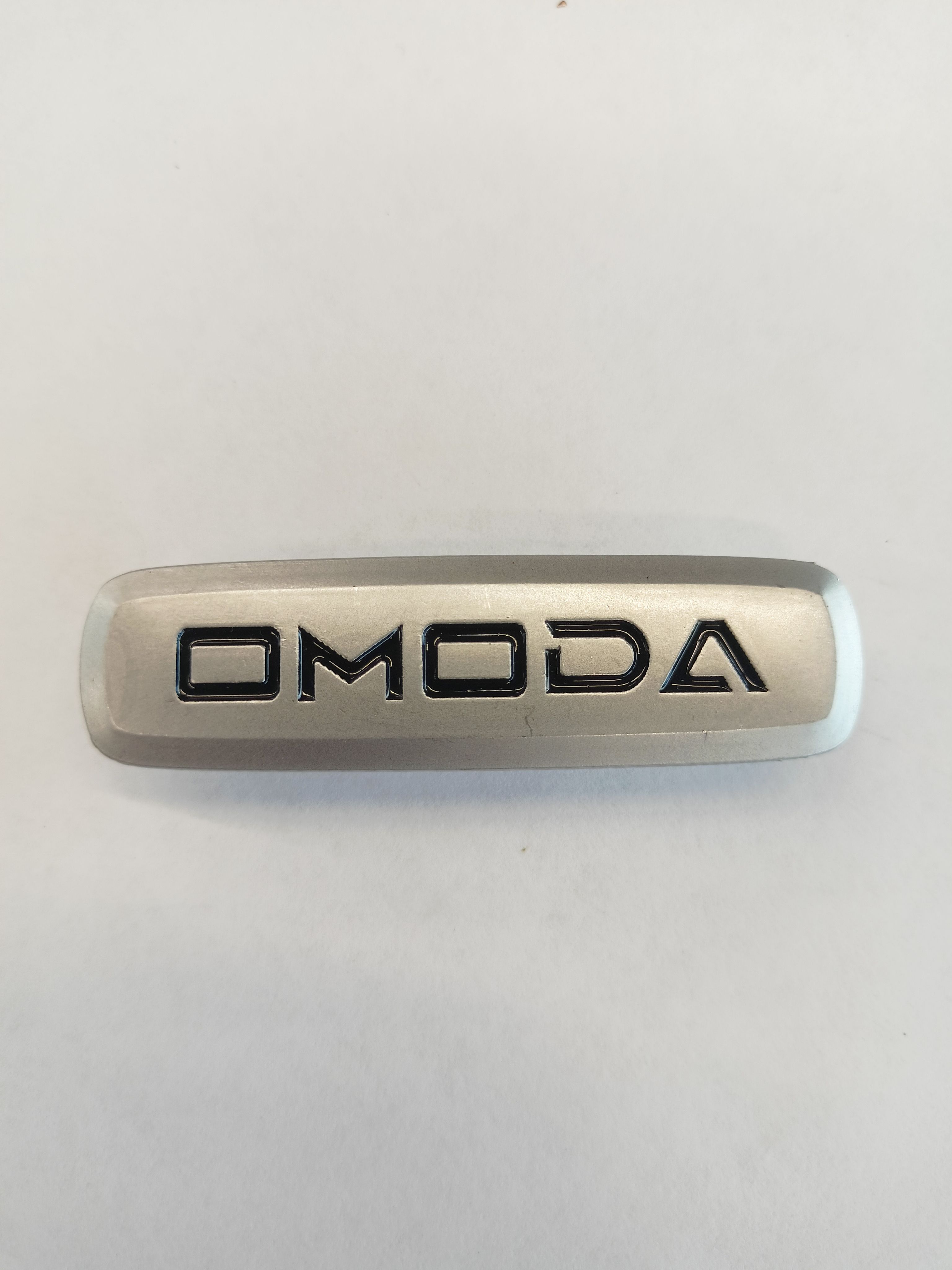 

Логотип с маркой автомобиля для ЭВА ковриков OMODA